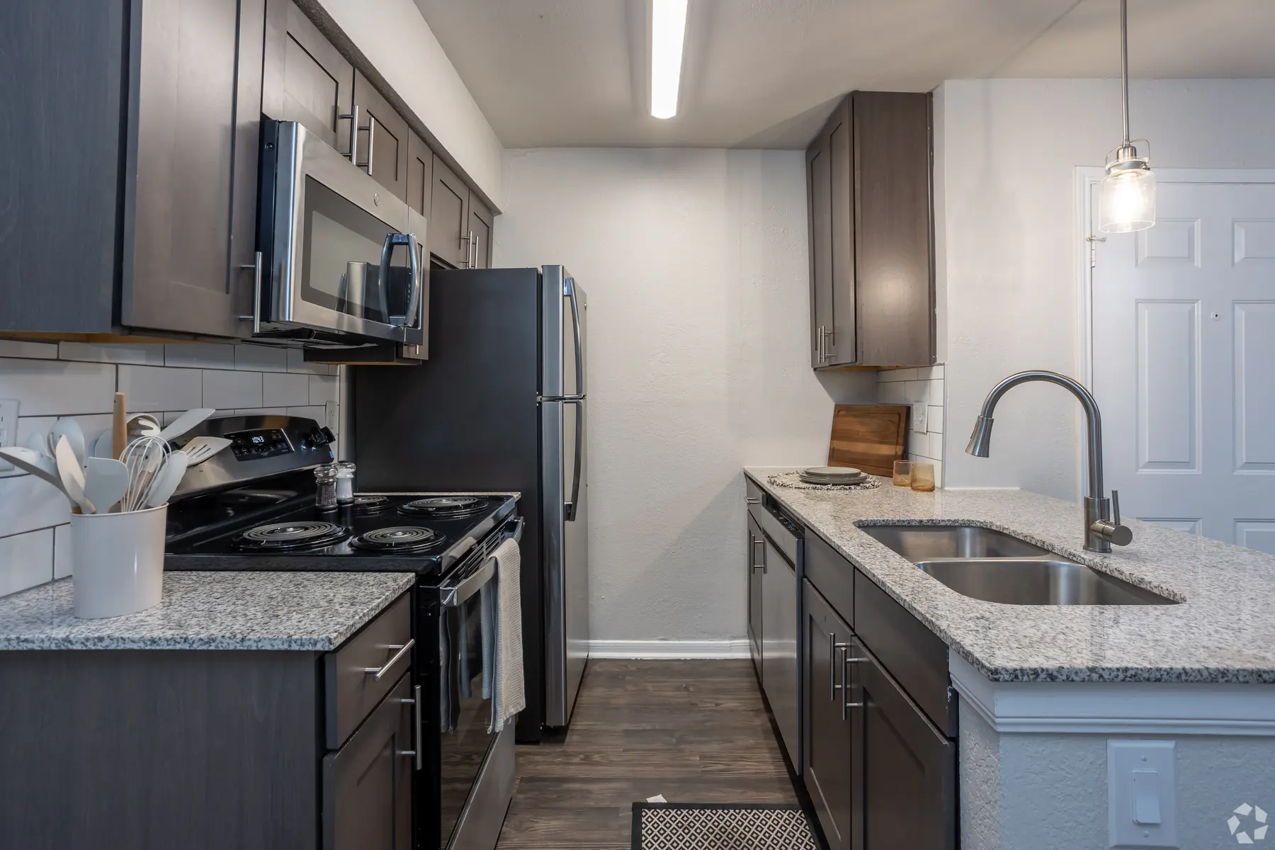 Modern Kitchen Interior Modern kitchen interior featuring dark cabinets, stainless steel appliances, and granite countertops.