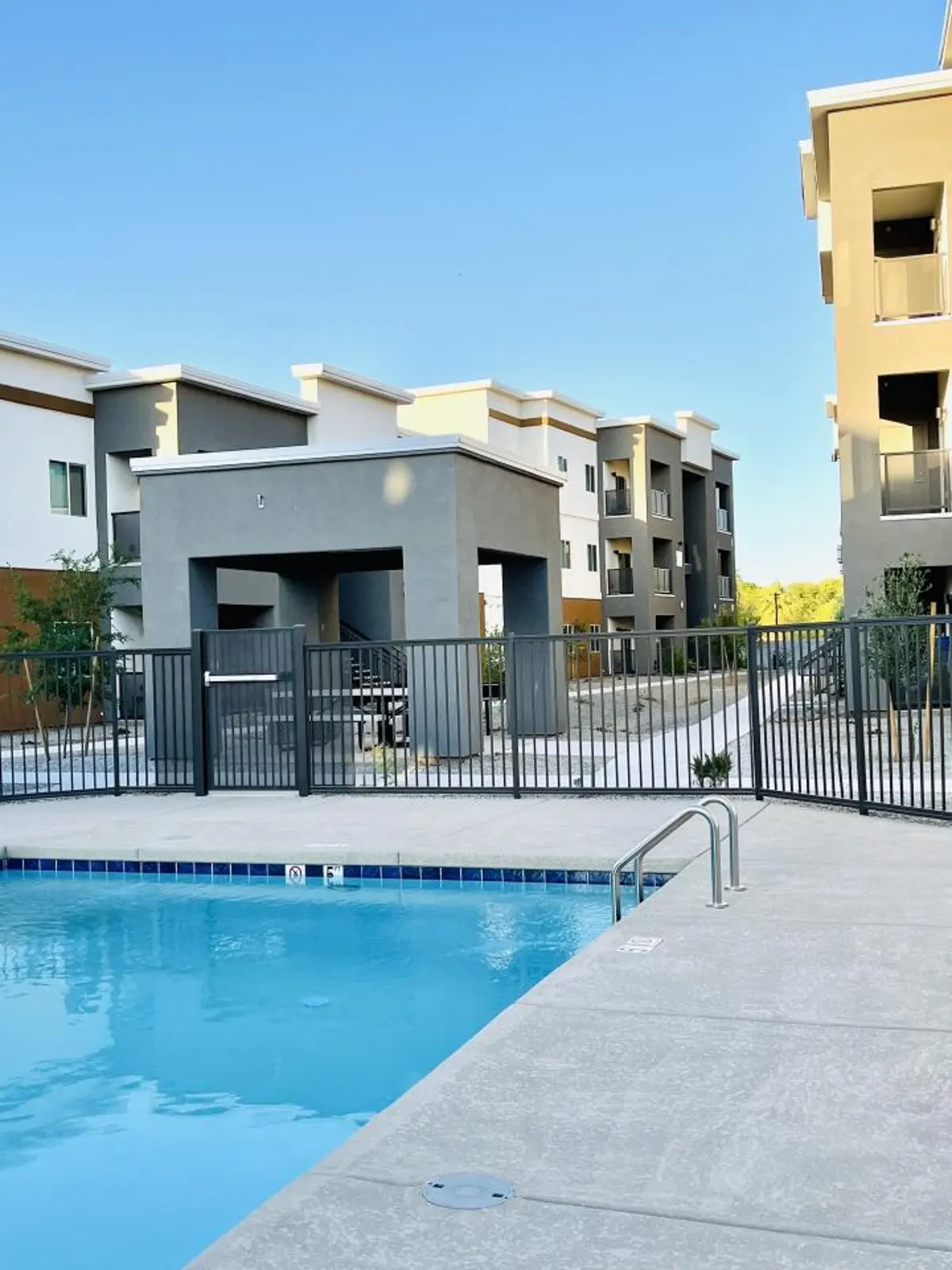 Pool beside apartment buildings.