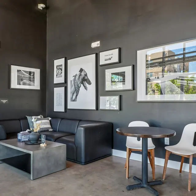 Contemporary Living Space A contemporary living space featuring a black wall, a sectional sofa, a coffee table, and framed artwork on the walls.