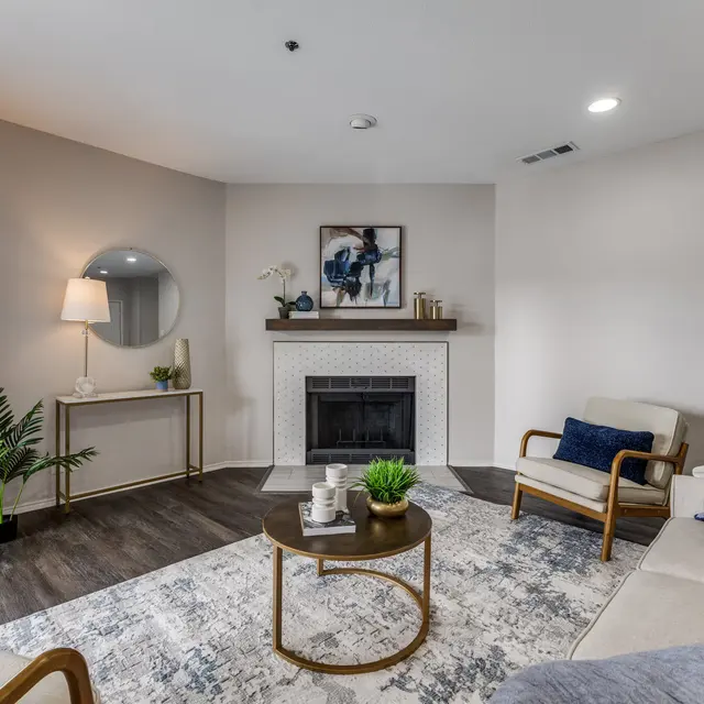 Stylish Modern Living Room A modern living room featuring a fireplace, plush seating, and decorative elements.