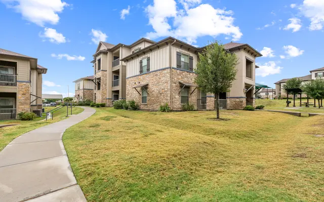 Apartment Complex Exterior Exterior view of an apartment complex with grassy area and walking path