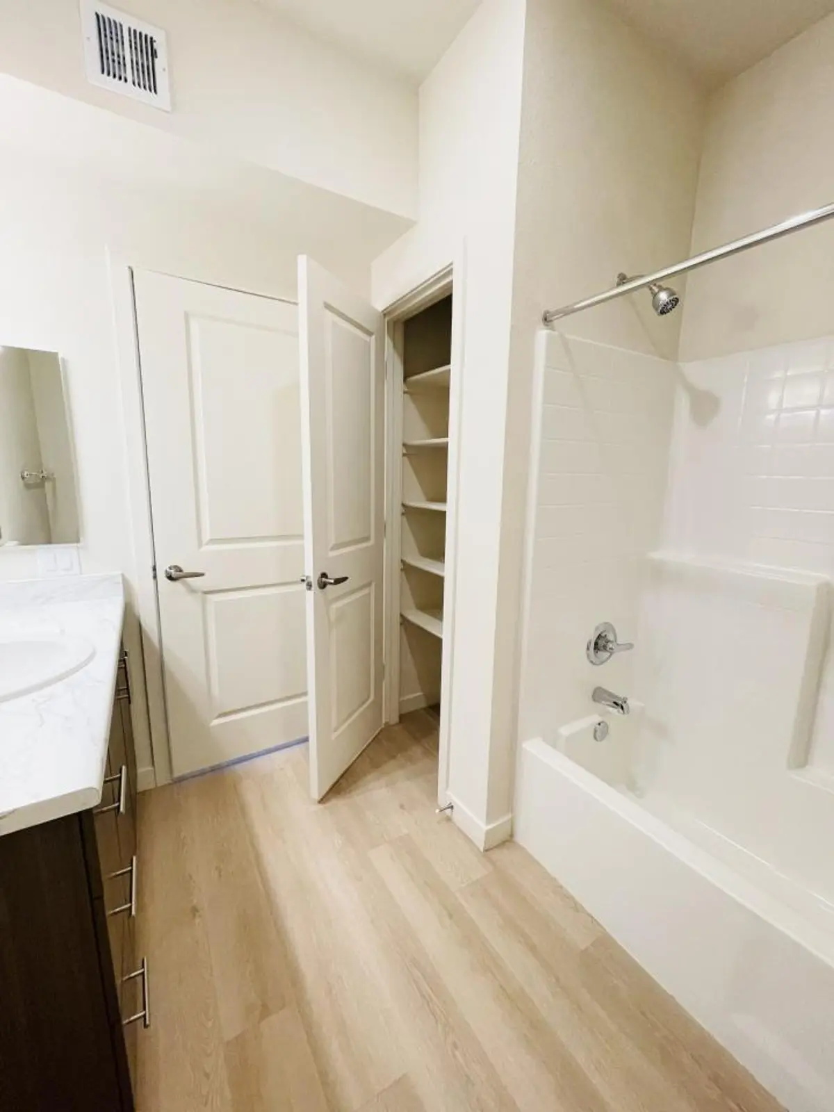 Bathroom with tub/shower, sink and linen closet.