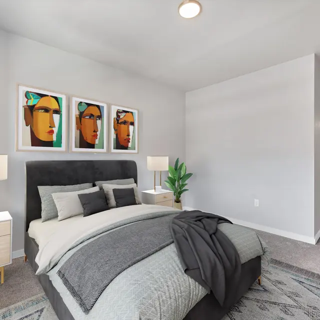 Stylish Modern Bedroom A modern bedroom featuring a black upholstered bed with gray bedding, two white nightstands with lamps, and abstract art on the walls. A green plant adds a touch of nature to the decor.