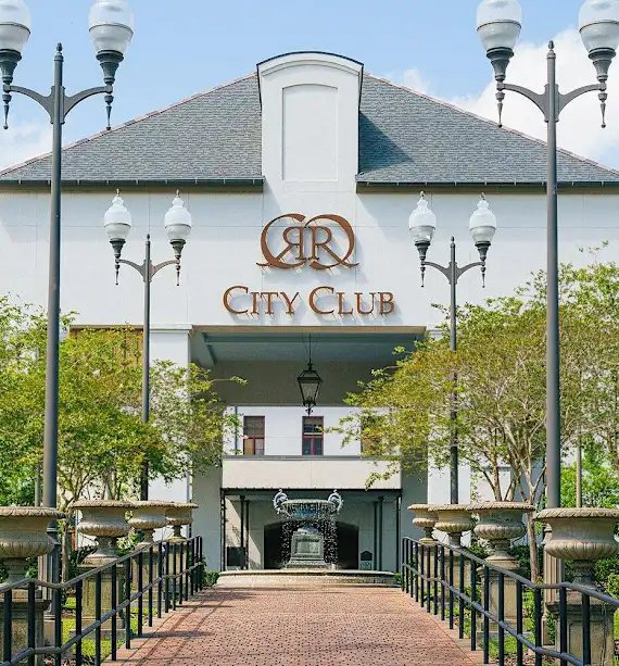 Entrance of a venue named City Club with decorative lampposts and landscaping.
