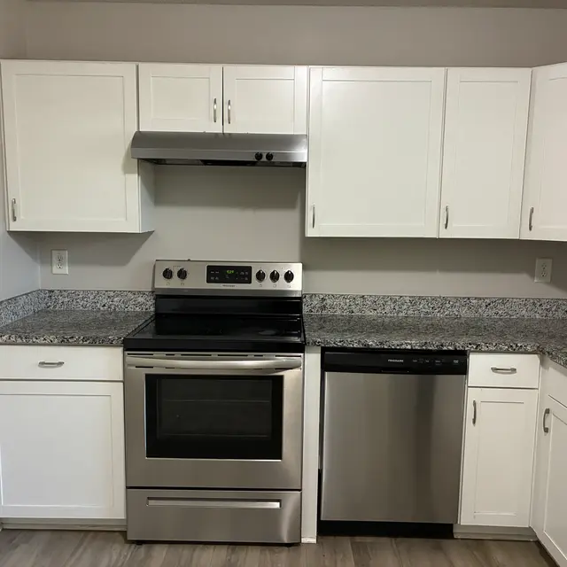 Contemporary Kitchen Design Modern kitchen with stainless steel appliances, white cabinets, and granite countertops.