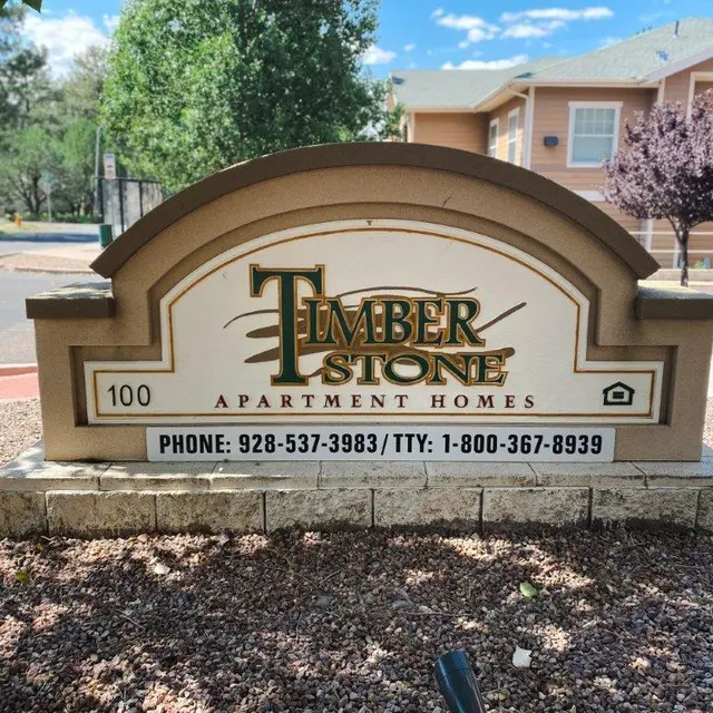 Sign for Timber Stone Apartment Homes with contact information