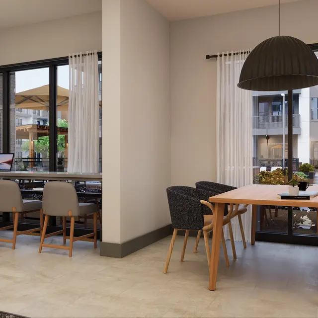 A stylish interior space featuring two distinct areas: a workspace with a long table and multiple chairs, and a dining area with a round table and four chairs. Large windows allow natural light to illuminate the room.