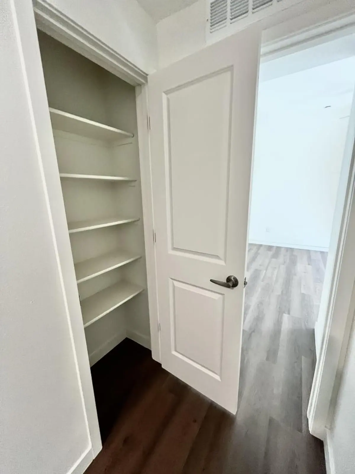 Open linen closet with built-in shelves.