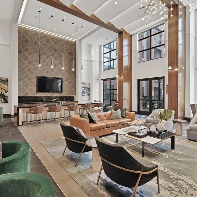 Stylish Modern Lobby A spacious modern lobby with high ceilings, large windows, and contemporary furniture including various seating arrangements and decorative elements.