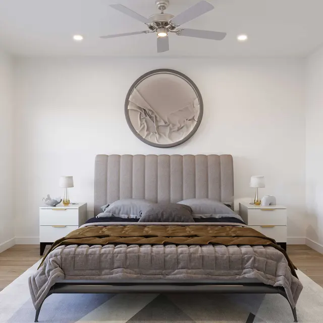 Spacious modern bedroom featuring a gray upholstered bed, decorative pillows, nightstands with lamps, a round wall clock, and natural light from windows