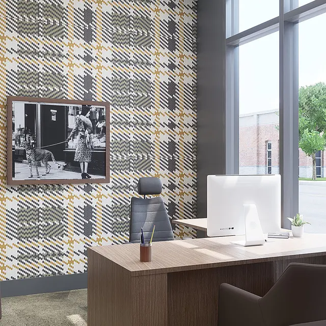 A modern office space with a stylish design, featuring a patterned wallpaper, a desk with a computer, an ergonomic chair, and a large window letting in natural light.