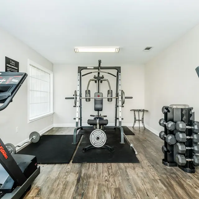 Fitness center featuring free weights, treadmill and workout machines