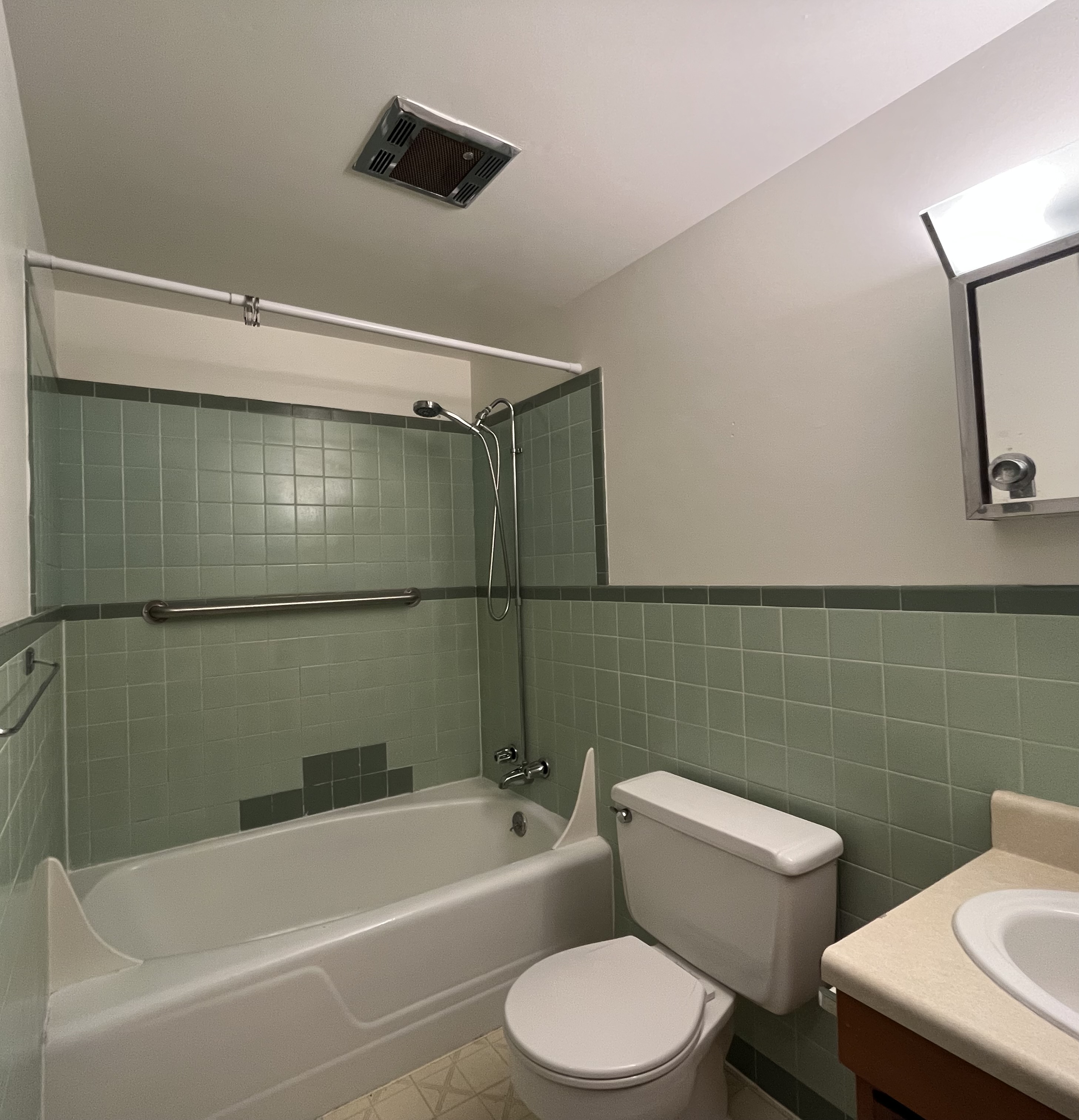 Undecorated bathroom in an apartment, featuring basic fixtures and clean design