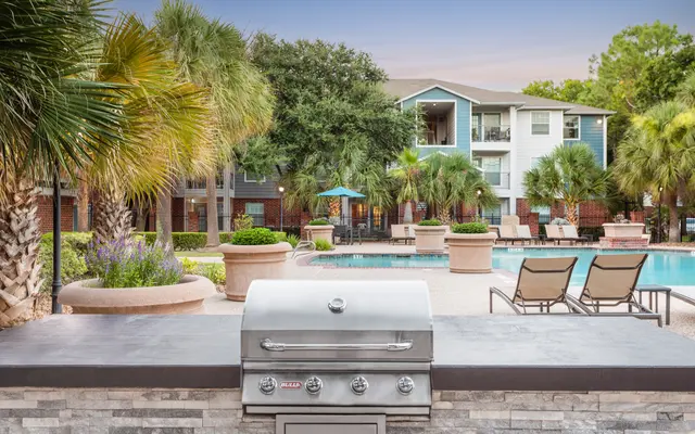 Patio seating and grilling area with poo in the background - Patio, Chair, Furniture
