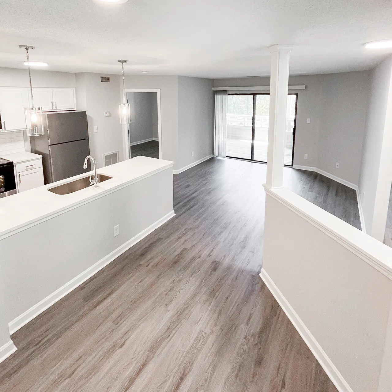 Modern Apartment Interior Spacious modern apartment interior featuring an open layout with a kitchen, living area, and large windows allowing natural light.