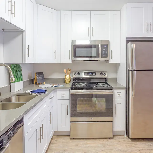 Modern kitchen with stainless steel appliances and white cabinetry