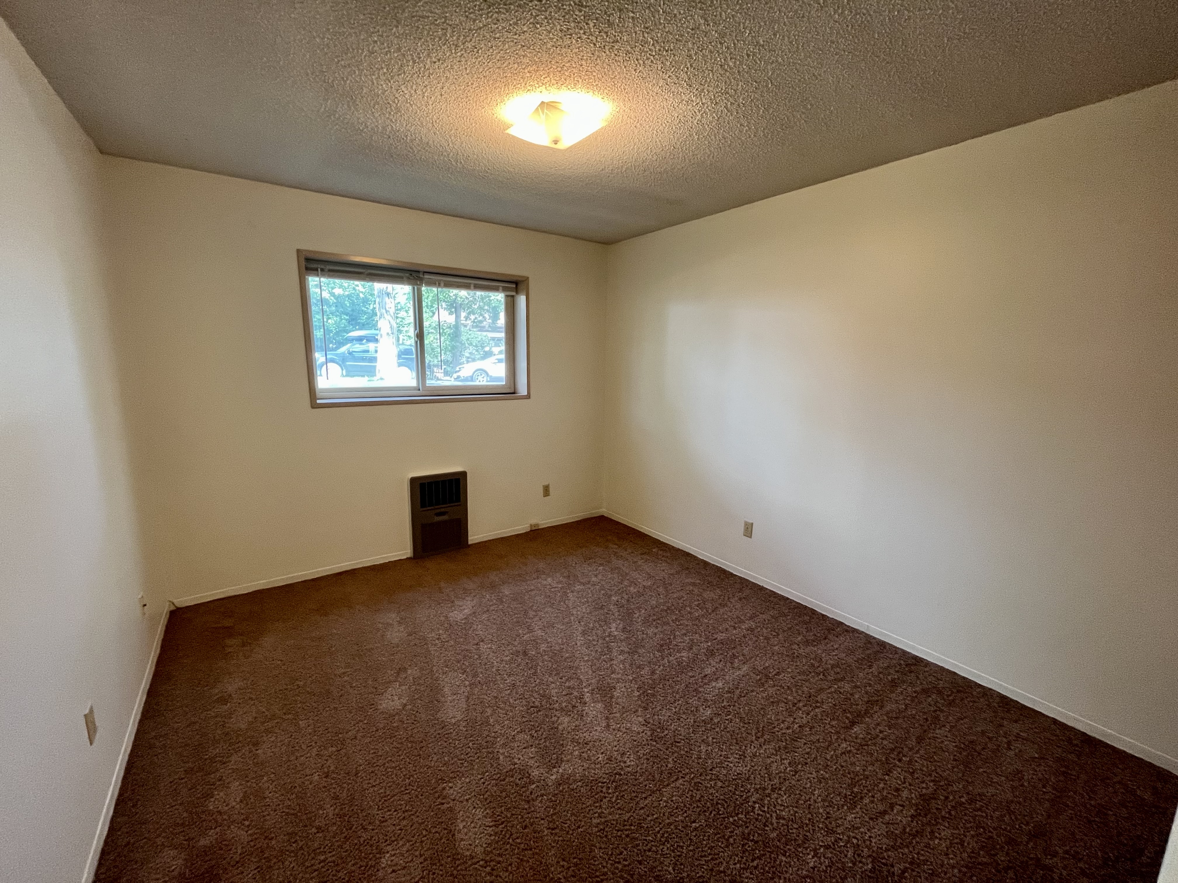 apartment bedroom in an unfurnished apartment, showcasing clean, spacious design. 