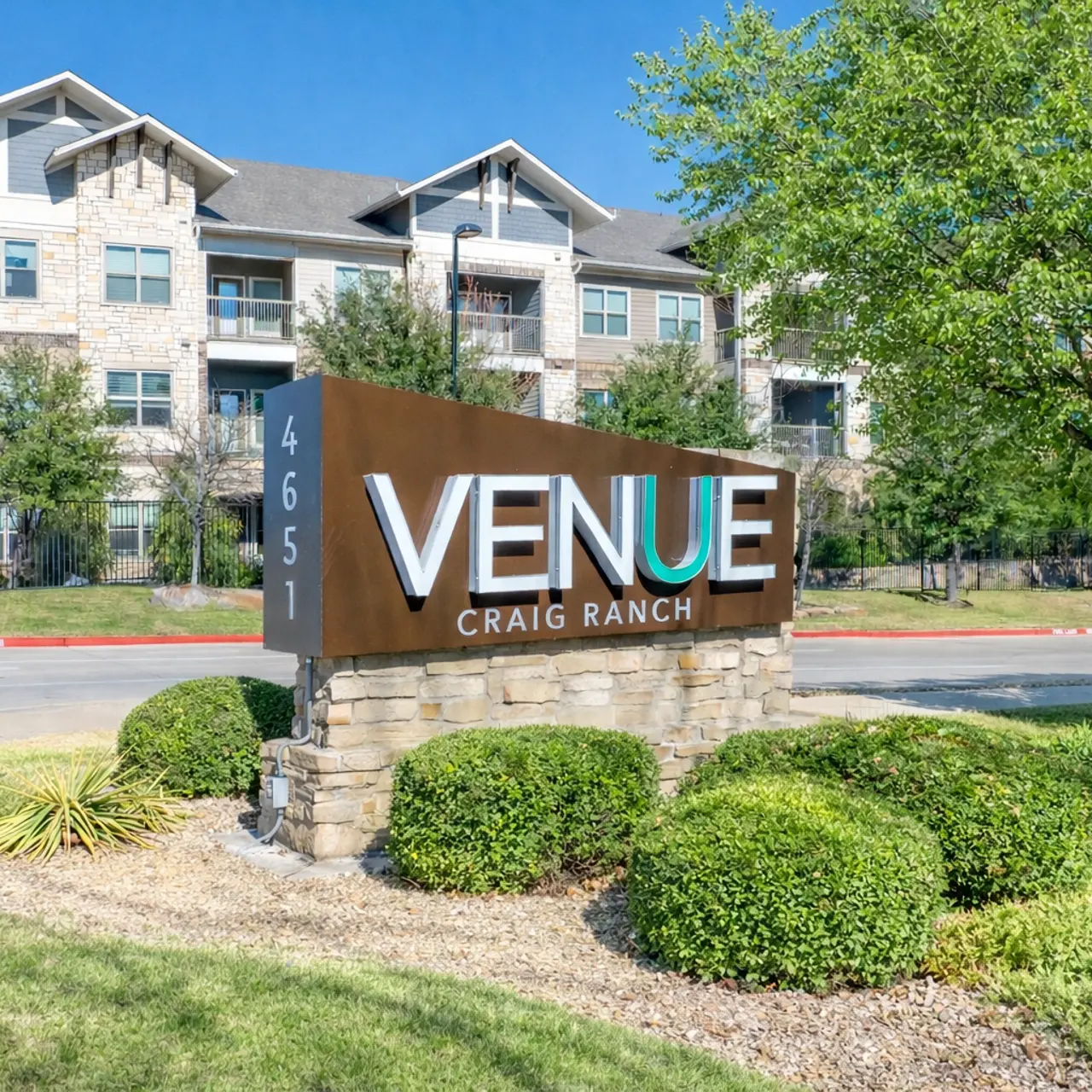 Monument Sign Exterior view of the Venue at Craig Ranch sign in front of a modern apartment building.