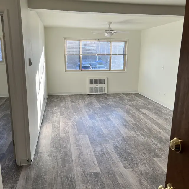 Primary bedroom in an unfurnished apartment, showcasing clean, spacious design.