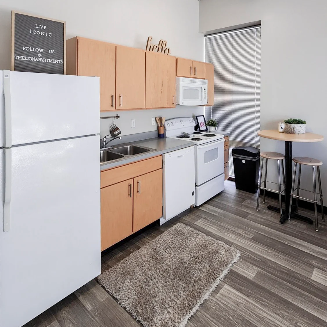 Modern Kitchen Design A modern kitchen with wooden cabinetry, white appliances, and a small dining area.