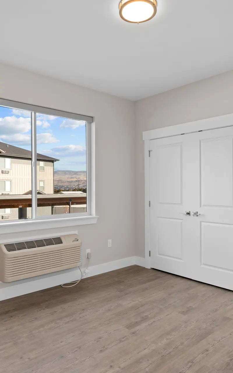 Primary bedroom in an unfurnished apartment, showcasing clean, spacious design