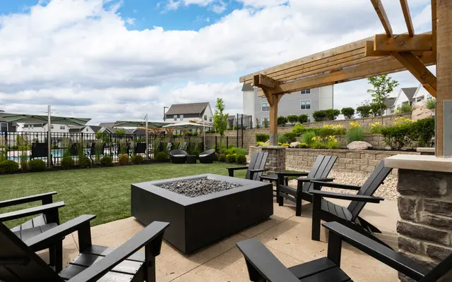 Stylish Outdoor Gathering Space Outdoor gathering space featuring black chairs and a fire pit
