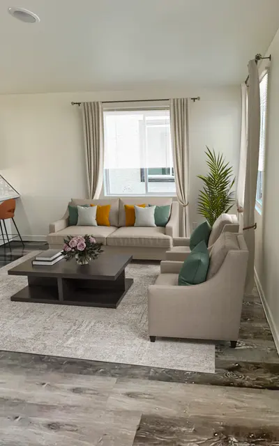 Raymond Place Four Bedroom Townhomes in South Phoenix AZ - Raymond Place - Living Room with Wood Flooring, Large Windows, Beige Sofas and Armchairs, Wooden Coffee Table, White Walls, and View of Kitchen