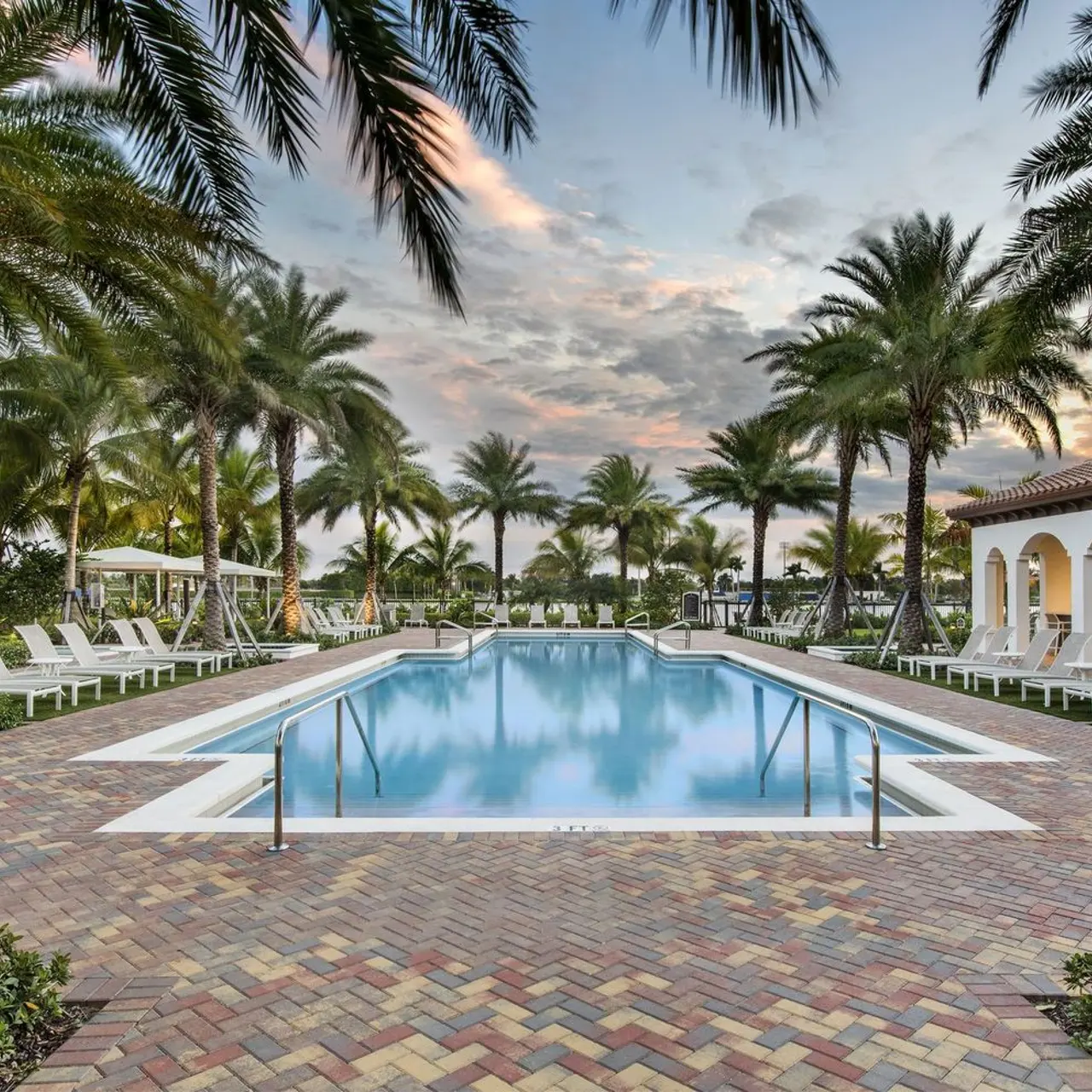 resort style pool and lounge seating under cabanas