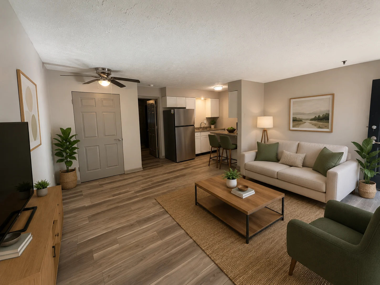 Stylish Living Room Interior A modern living room with a beige sofa, green accents, wooden coffee table, and kitchen area in the background.