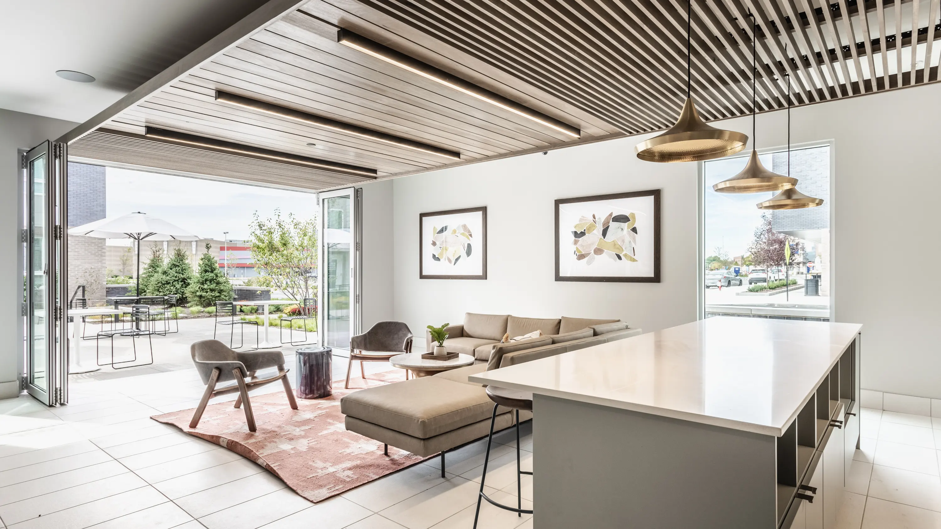 Modern Living Space with Open Layout A modern living space with large windows, a minimalist design, and a cozy seating arrangement. The area features a sofa, armchairs, and a coffee table, complemented by a stylish rug. Natural light floods the room, enhancing its open feel.
