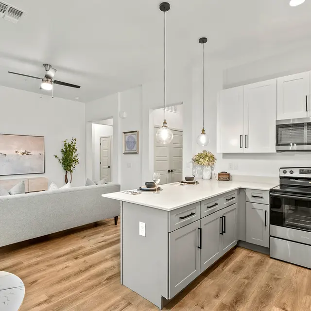 Open-concept apartment layout with modern kitchen and living area at The Farmhouse on Estrella