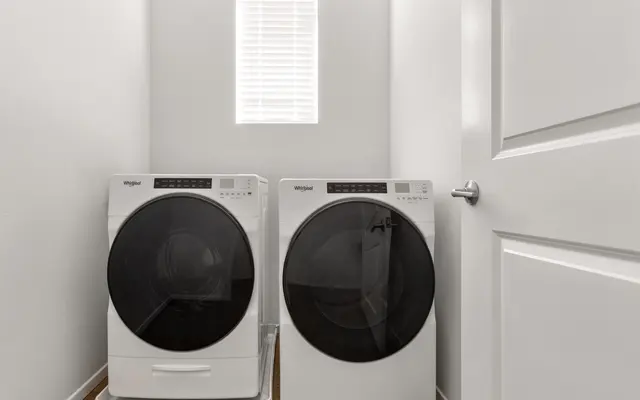 side-by-side washer and dryer in white-walled closet at apartment in Ewa Beach, HI