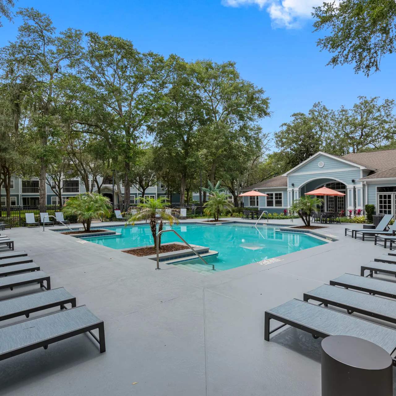 large resort style swimming pool with lounge seating