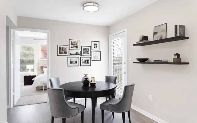 Dining room area with doors and art frames hanging on the wall - Chair, Furniture, Interior Design