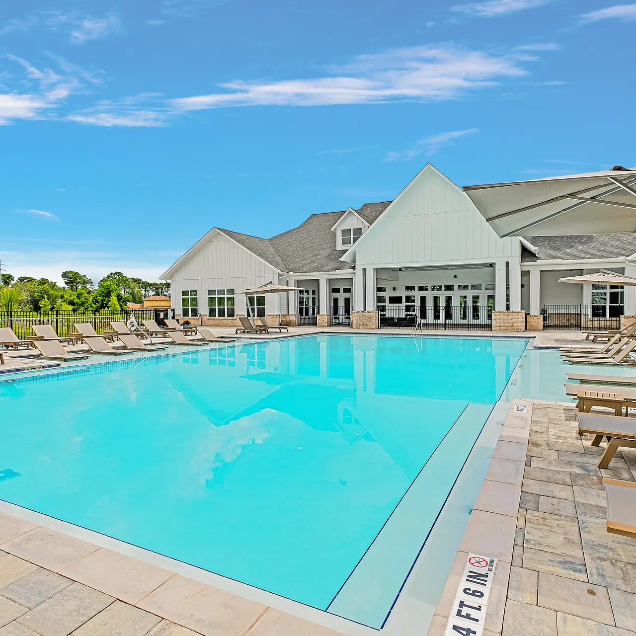 large resort style pool with lounge seating all around