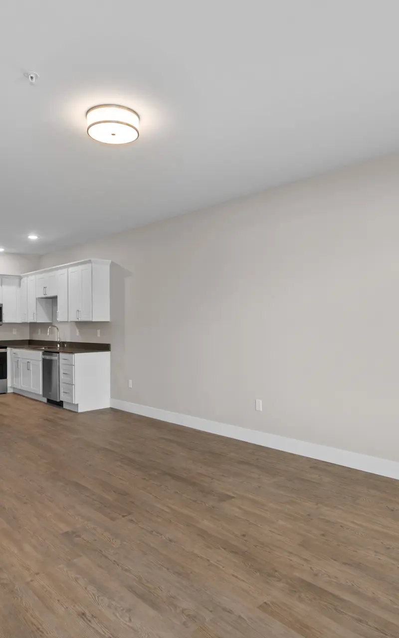 An unfurnished apartment, showcasing empty rooms with bare floors and walls, providing a blank canvas for personalization and decor