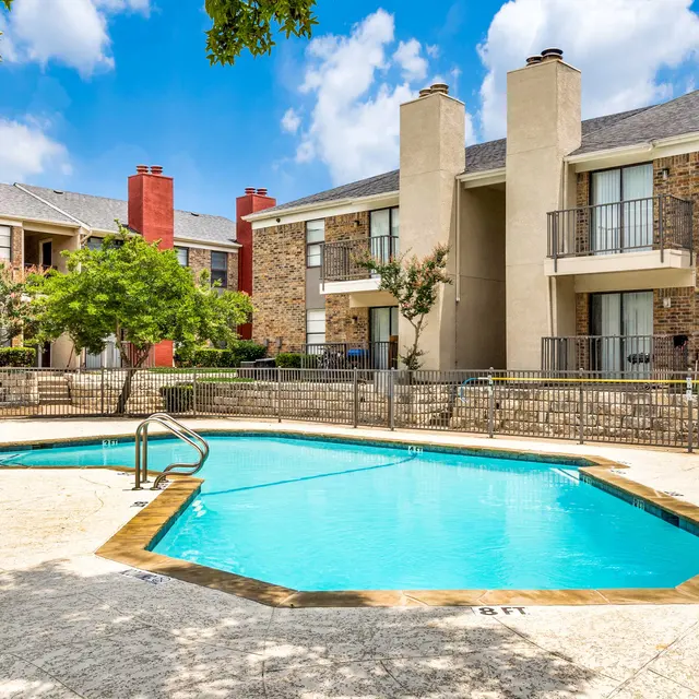 Gated pool surrounded by North Star Apartments in Dallas, TX