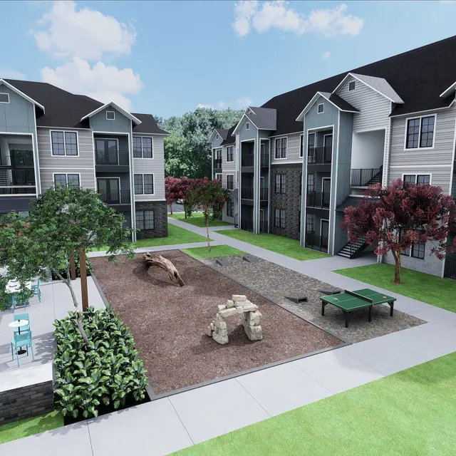 A modern apartment complex featuring two buildings with multiple stories, surrounded by green landscaping, a playground area, and outdoor seating.