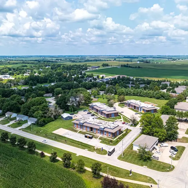 Aerial view of a rural town with residential areas and green fields