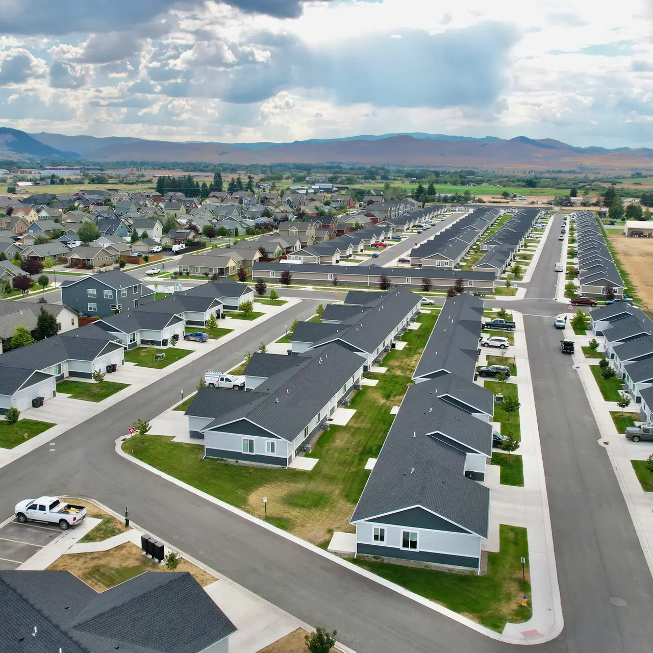 apartment aerial view Aerial view of Elkhorn Flats apartment complex in Helena, MT, showcasing its layout and surrounding environment, including mountains