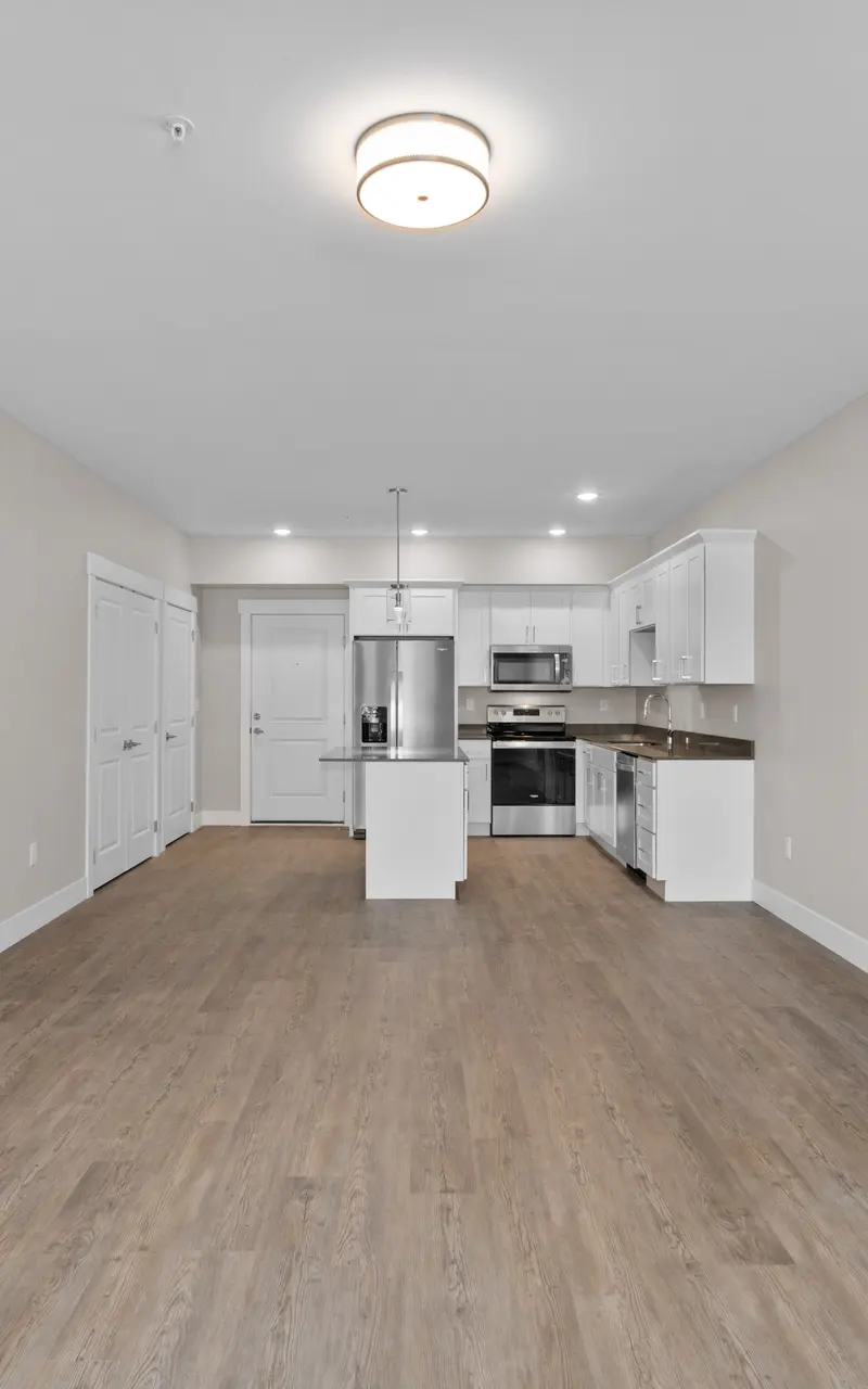 An unfurnished apartment, showcasing empty rooms with bare floors and walls, providing a blank canvas for personalization and decor