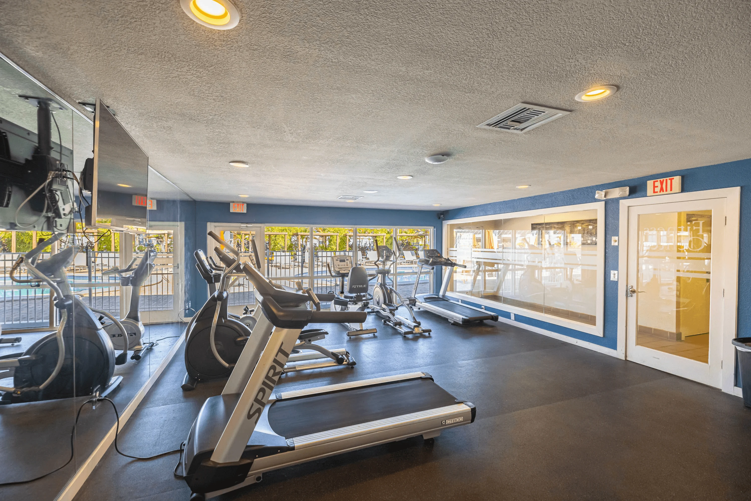 Interior view of a gym with treadmills and exercise equipment.