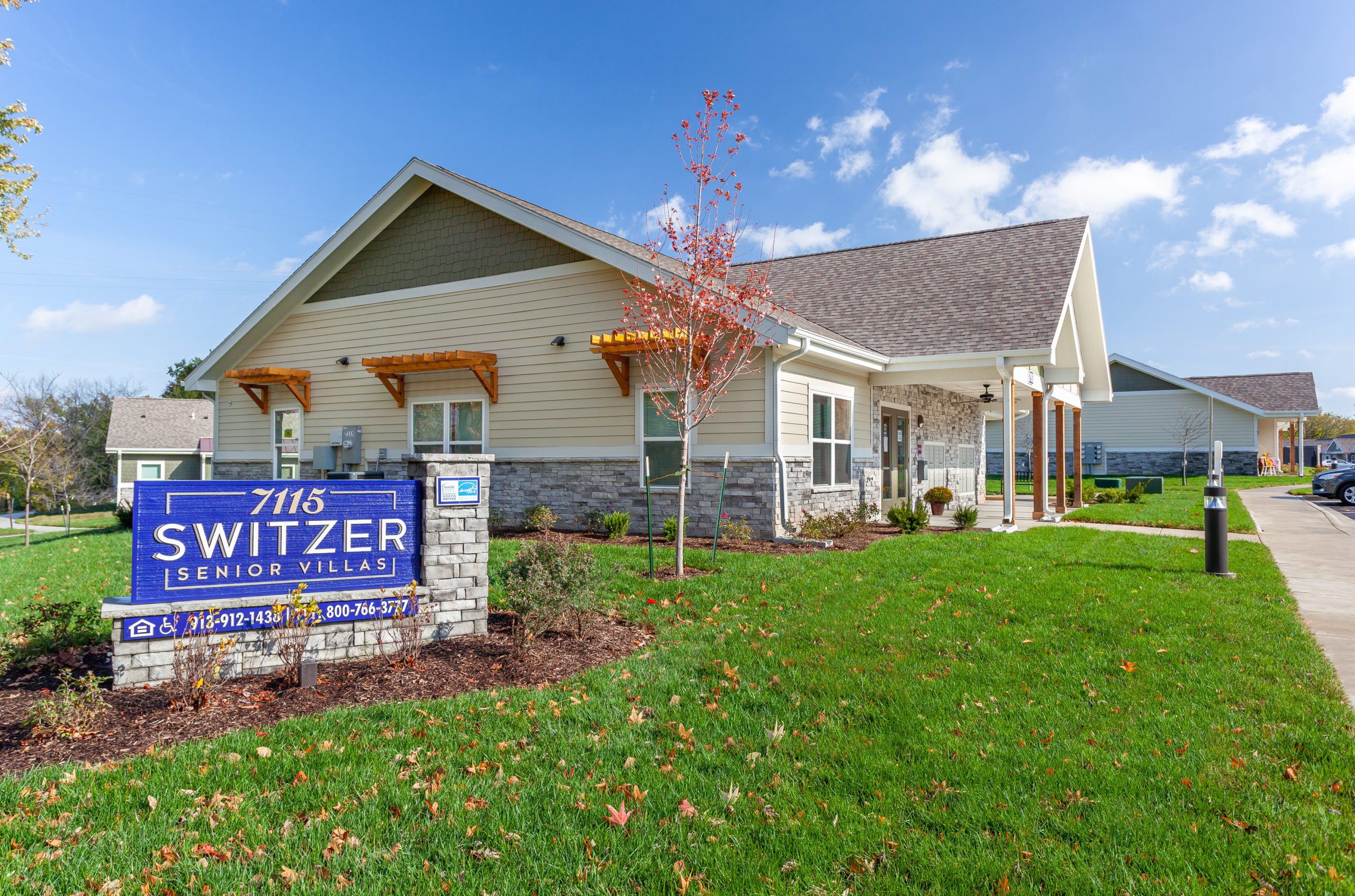 Switzer Senior Villas Exterior Exterior view of Switzer Senior Villas with a large sign in front and well-maintained landscaping.