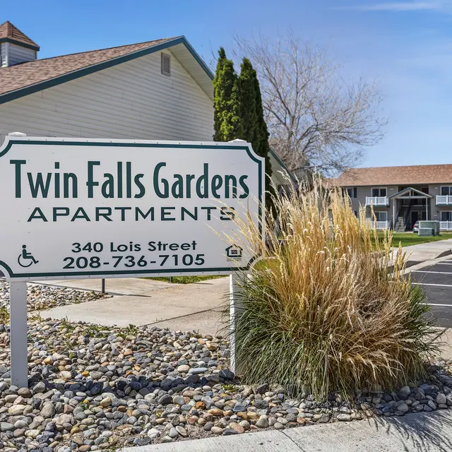 Twin Falls Gardens Apartments Sign Sign for Twin Falls Gardens Apartments with a landscaped area in front.