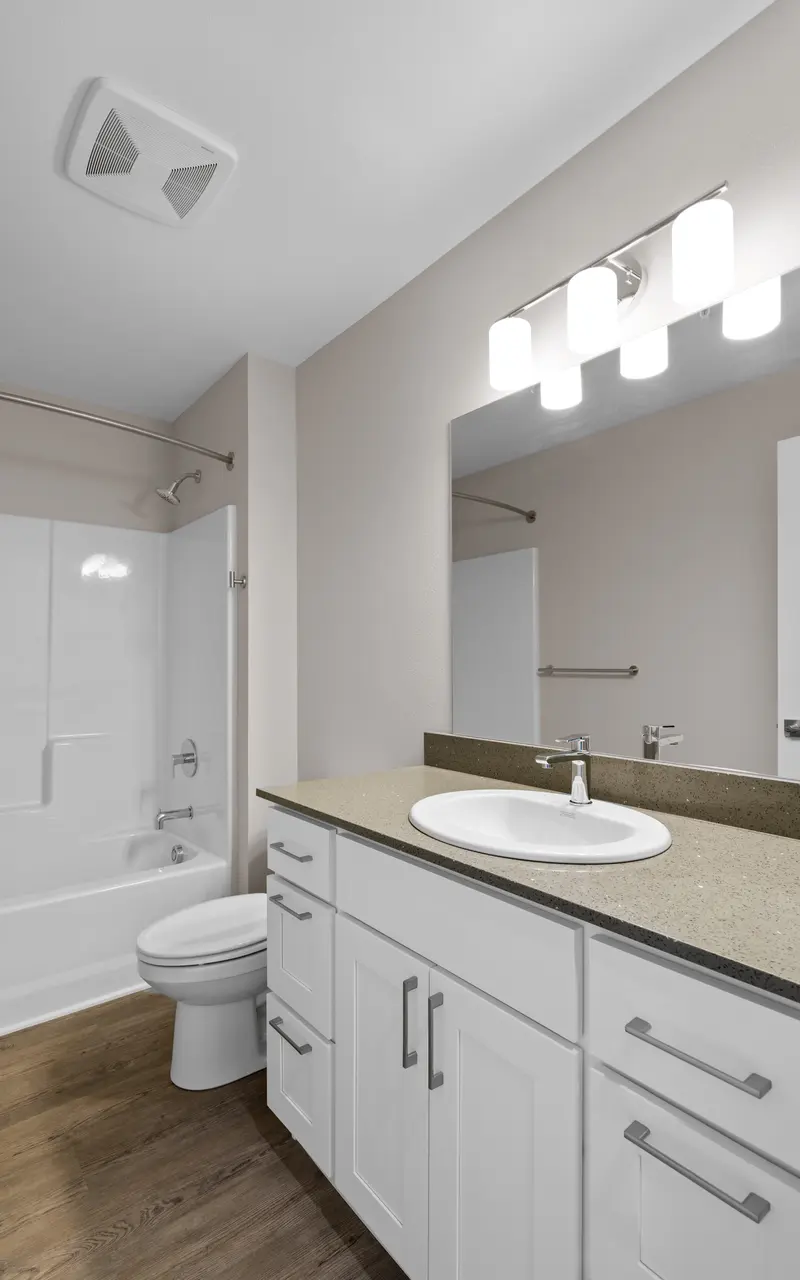 Undecorated bathroom in an apartment, featuring basic fixtures and clean design
