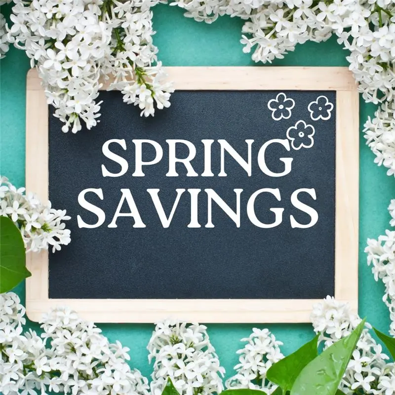 Spring Savings Promotion Chalkboard sign with the text 'SPRING SAVINGS' surrounded by white flowers and green leaves on a turquoise background.
