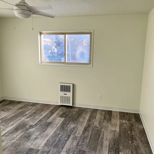 Primary bedroom in an unfurnished apartment, showcasing clean, spacious design.