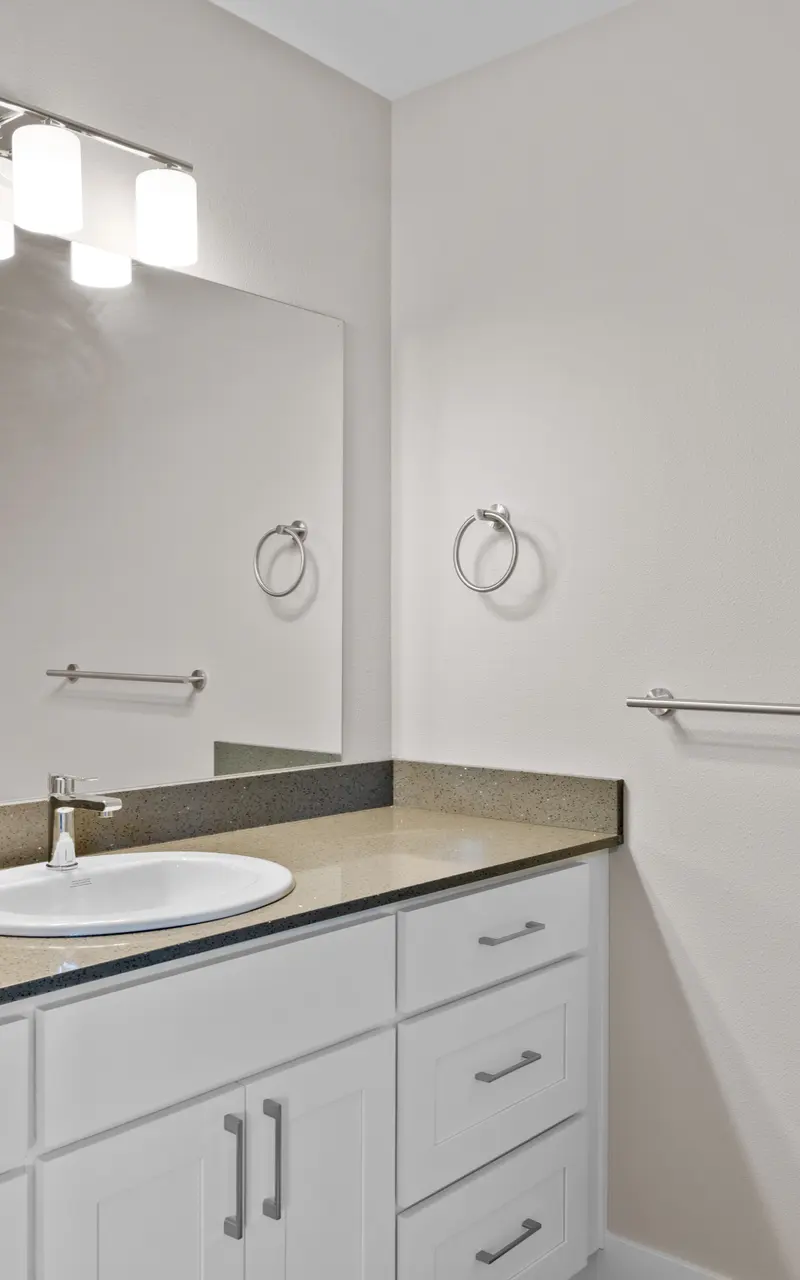 Undecorated bathroom in an apartment, featuring basic fixtures and clean design