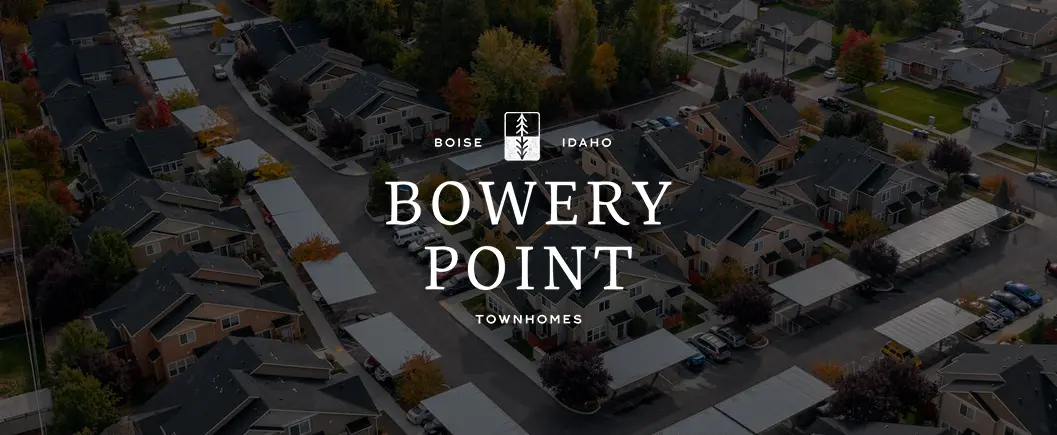 Aerial view of Bowery Point townhomes in Boise, Idaho with lush greenery in the background.