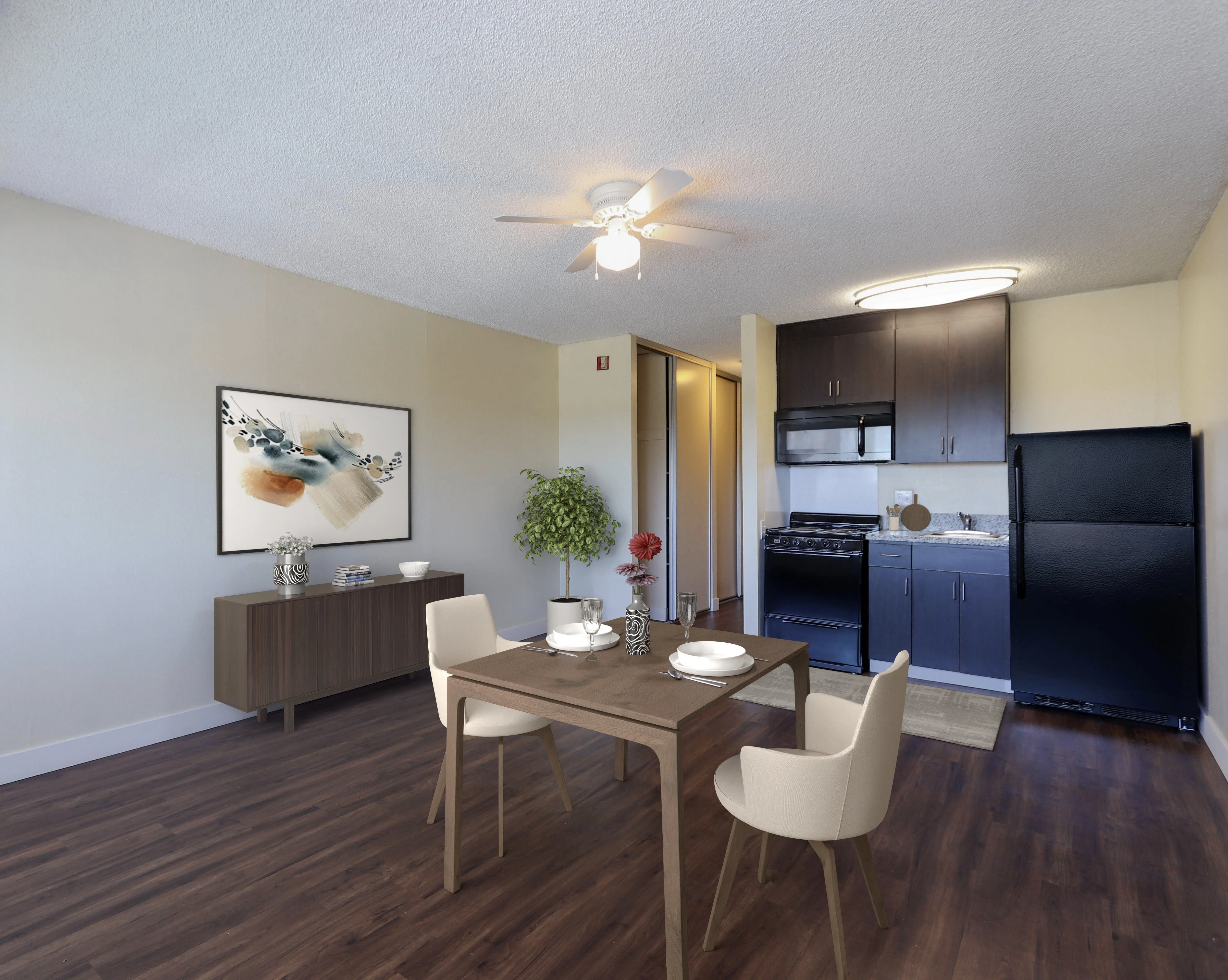 Modern Kitchen and Dining Area A modern kitchen and dining area featuring a wooden dining table with white chairs, a sideboard, and an art piece on the wall. The kitchen has dark cabinetry and stainless steel appliances.